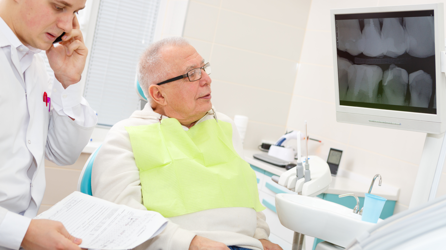 Elderly man on a review of a dentist, sitting in a chair